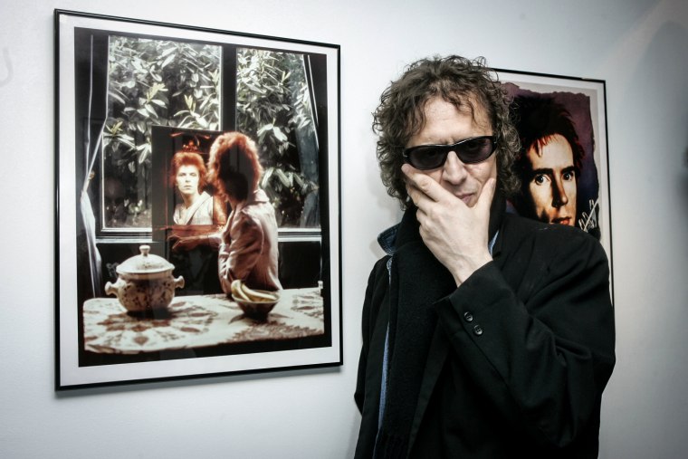 Mick Rock with his portraits of David Bowie and John Lydon on March 24, 2005.