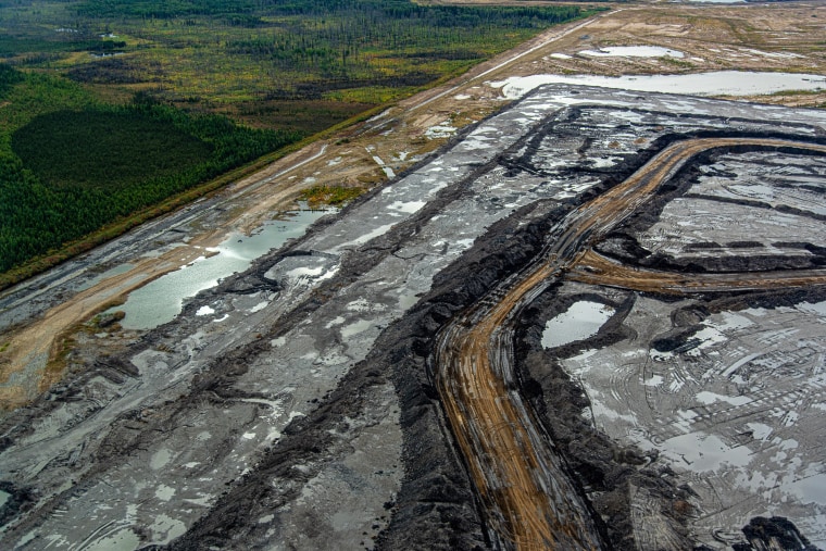 An oil sands mine in Alberta, Canada adjascent to boreal forest outside of Fort McMurray.