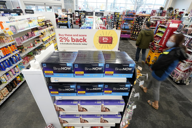 Boxes of BinaxNow home Covid-19 tests made by Abbott and QuickVue home tests made by Quidel are shown for sale Nov. 15, 2021, at a CVS store in Washington.