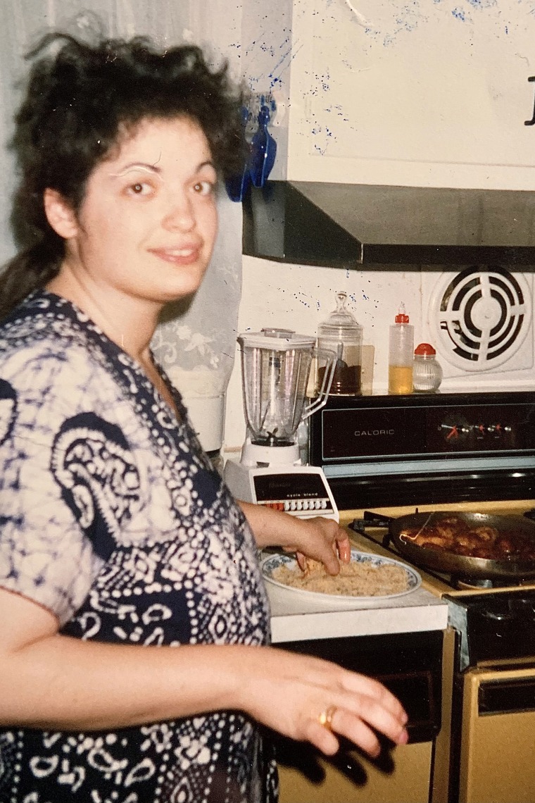Raj's mom preparing dinner in their kitchen in the early 1990s.
