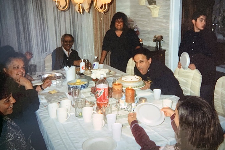 Raj, standing behind his dad on the right, with his family during Thanksgiving dinner in the late 1990s.