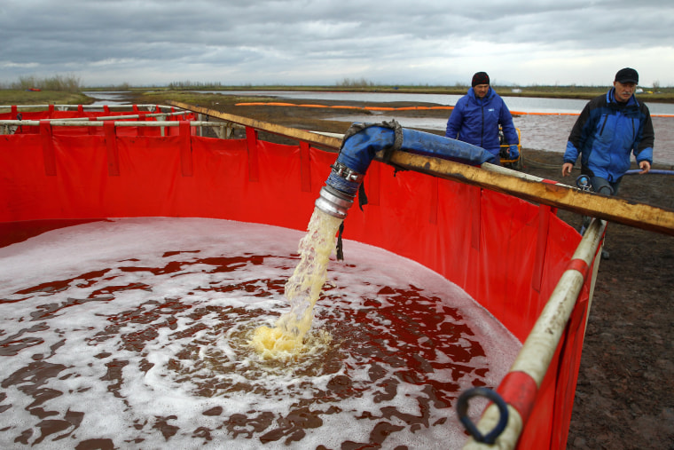 Image: Employees of Russia's state-owned oil pipeline monopoly Transneft during a clean-up operation following a massive fuel spill in the Ambarnaya River outside Norilsk on June 10, 2020.