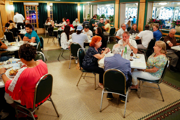 People have dinner during the 50th anniversary of the Cuban restaurant Versailles in Miami on Nov. 10, 2021.