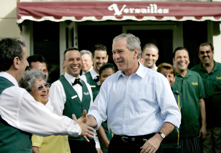 President George W. Bush greets cafe staff and workers after breakfast with business leaders at Versailles in Miami on July 31, 2006.