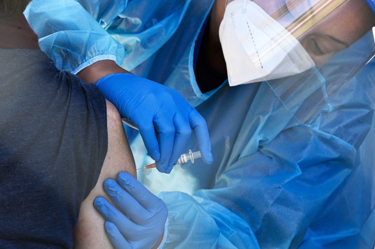 A health worker administers a flu vaccine in San Fernando, Calif., on Nov. 24, 2020.