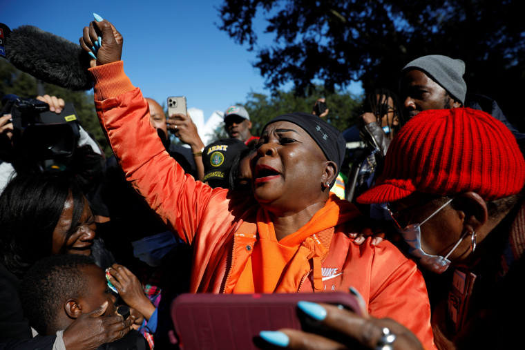 A woman raises a fist as she reacts outside the Glynn County Courthouse after the jury reached a guilty verdict in the trial of William "Roddie" Bryan, Travis McMichael and Gregory McMichael, charged with the February 2020 death of 25-year-old Ahmaud Arbery, in Brunswick, Ga., Nov. 24, 2021.