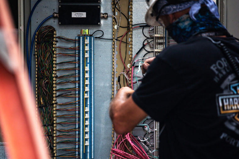 An employee of Vistra Corp.’s Midlothian Power Plant in Midlothian, Texas, adjusts the wiring of a power unit on Oct. 15, 2021. Energy providers like Vistra are preparing their plants for extreme weather conditions following the February winter storm Uri, which disrupted the Texas electric grid and led to the deaths of more than 200 people.