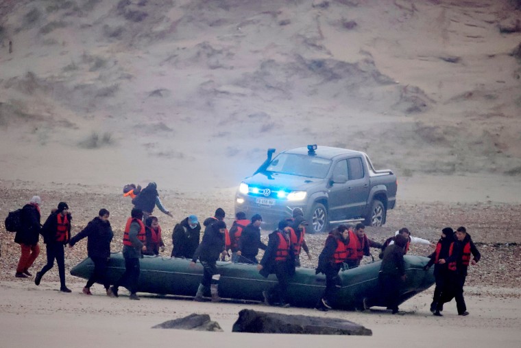 Image: Migrant dinghy heads off the French coast to cross the English channel