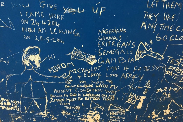 Messages are scrawled on a wall in the Gharyan Detention Center in Libya.
