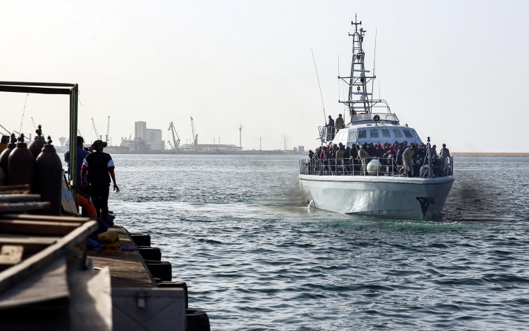 A Libyan coastguard vessel carries migrants recovered off the coast of al-Khums, about 120 kilometres east of the capital, as it approaches the pier in Tripoli's naval base on Feb. 10, 2021.