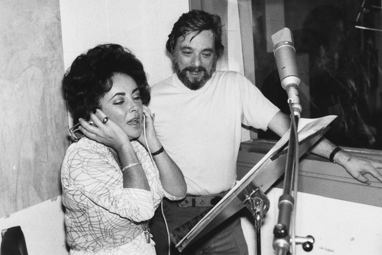 Elizabeth Taylor records songs for the film "A Little Night Music" alongside Stephen Sondheim, who wrote the music and lyrics for the film, at a recording studio in England on Aug. 10, 1976.