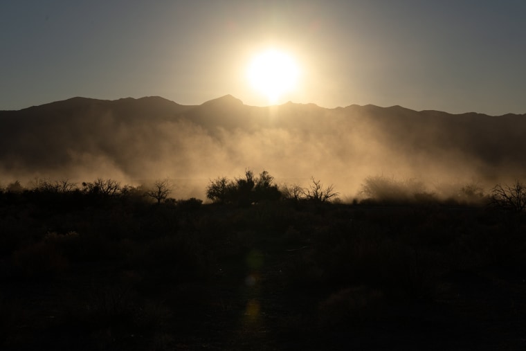 Dust settles after an off-road vehicle travels across federal land where the proposed Rough Hat solar project could be constructed in Pahrump, Nev., on Nov. 27, 2021.