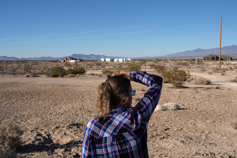 Jeanne Wright looks off her property in Pahrump, Nev., on Nov. 27, 2021. Surrounding her and her neighbors is federal land where the proposed Rough Hat solar project could be constructed.