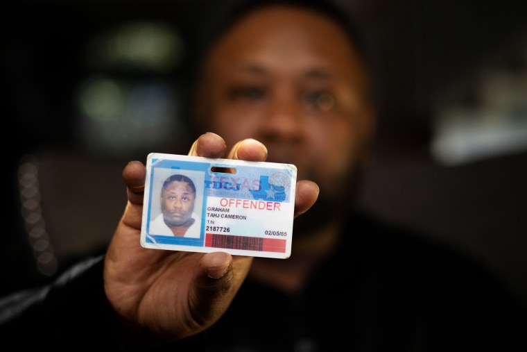 Image: Tahj Graham holds the Texas offender card he used for identity while incarcerated in the Texas Department of Criminal Justice women's prison in Gatesville, Texas.