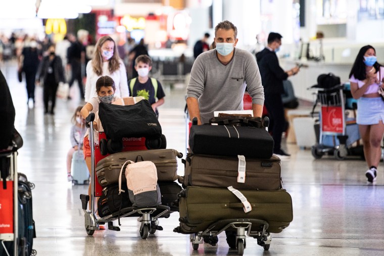 Image: Travellers arrive at the international terminal at Sydney Airport in Sydney