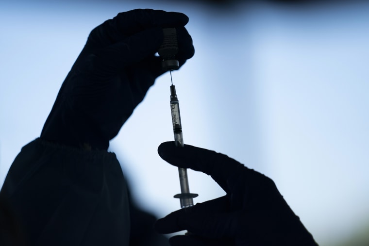A medical staff member prepares the Pfizer-BioNTech COVID-19 vaccine at Tudor Ranch in Mecca, Calif. on Jan. 21, 2021.  Merriam-Webster has declared vaccine its 2021 word of the year. (AP Photo/Jae C. Hong, File)