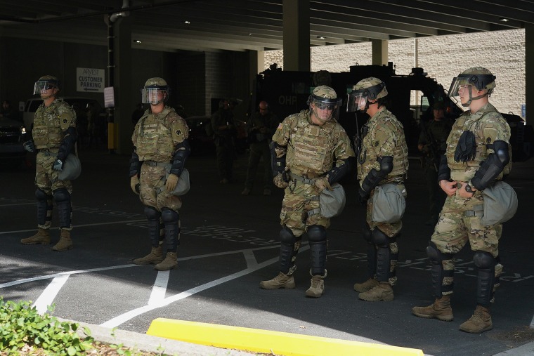 Image: Members of the Oklahoma National Guard stage in a parking garage prior to a rally for President Donald Trump on June 20, 2020 in Tulsa, Okla.