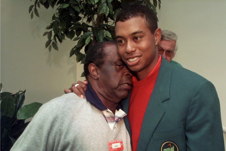 Masters champion Tiger Woods gets a hug from Lee Elder after the final round of the Masters at Augusta National Golf Club in Augusta, Ga., on April 13, 1997. 