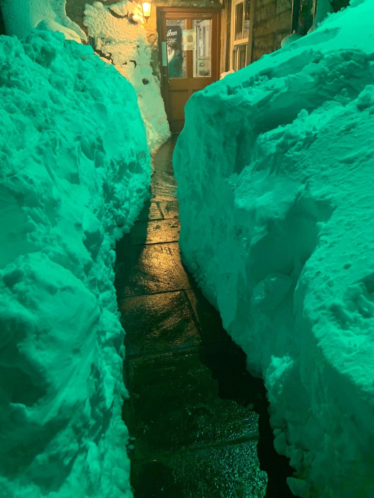 Stranded staff and guests dug a path out of the pub which had been blocked by thick snow.