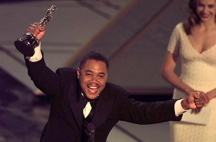 Actor Cuba Gooding, Jr holds up his Oscar after wi