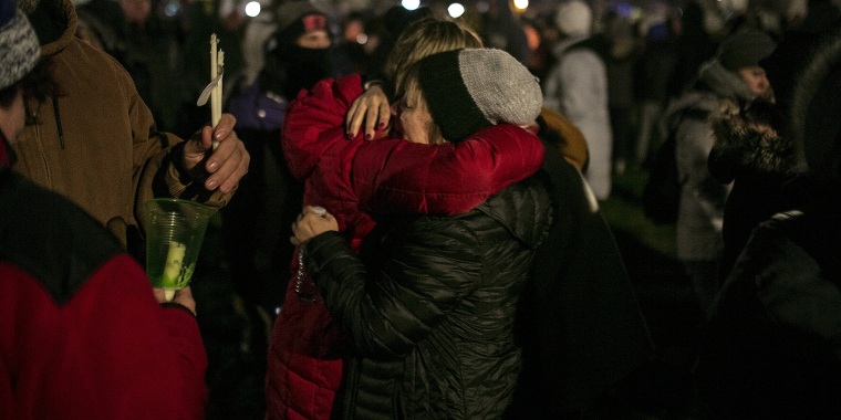 People embrace one another during a vigil Monday in Waukesha, Wisconsin, for the five people killed when a suspect drove an SUV through a holiday parade route. 
