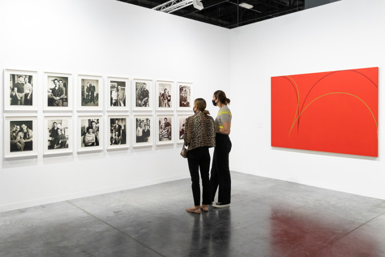 Art Basel attendees viewing Sunil Gupta’s “Lovers: Ten Years Later” photo series at the Miami Beach Convention Center on Dec. 2, 2021.