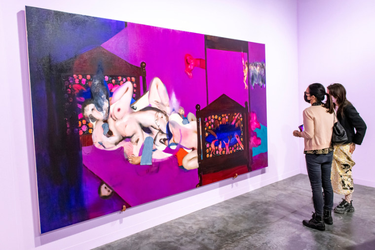 Art Basel attendees viewing a painting by Ambera Wellmann at the Miami Beach Convention Center on Dec. 2, 2021.