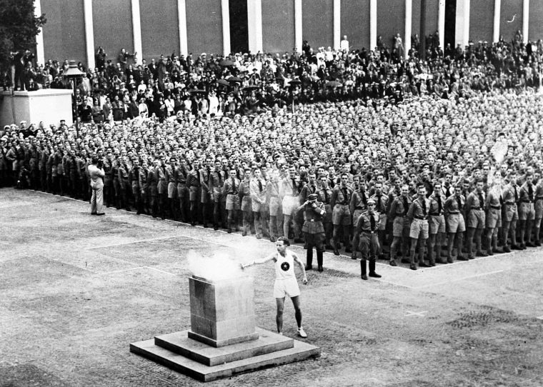 The Olympic flame is lit in Lustgarten, Berlin on Aug. 1, 1936, where it was guarded by members of Hitler Youth before being brought to the Olympic stadium for the opening of the games.