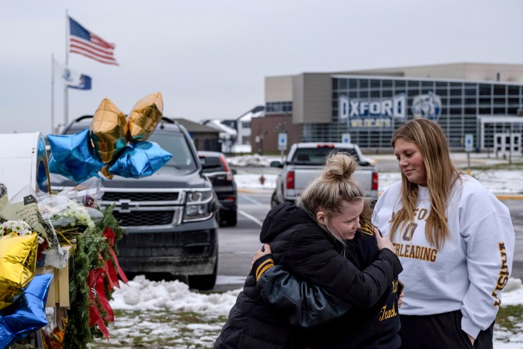Image: People pay their respects at a memorial at Oxford High School, a day after a shooting that left four dead and eight injured, in Oxford