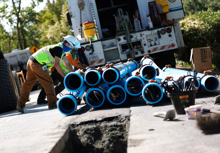 Workers with East Bay Municipal Utility District (EBMUD) stack water pipes before installation on April 22 in Walnut Creek, California. President Joe Biden introduced his $2 trillion infrastructure and jobs package that will overhaul the nation’s water systems, including the replacement of all lead pipes.