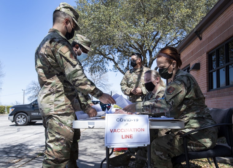 Members of the 149th Fighter Wing check in for their appointments to get Covid-19 vaccine shots at Joint Base San Antonio-Lackland, Texas, on  March 18. 