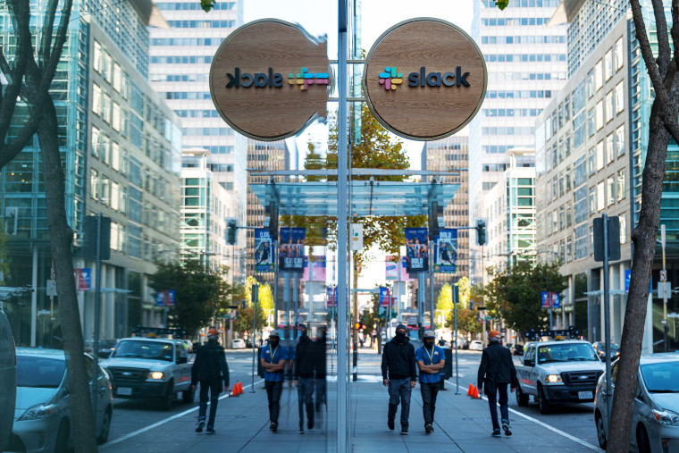 Image: Pedestrians walk past Slack headquarters in San Francisco on Dec. 2, 2020.