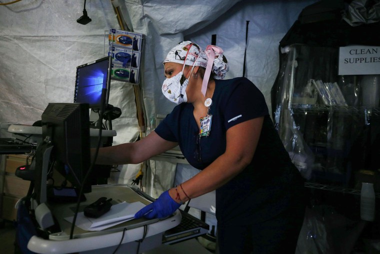 Image: A nurse works in a makeshift tent triage center for Covid-19 patients in El Centro Regional Medical Center in hard-hit Imperial County on July 21, 2020 in El Centro, Calif.