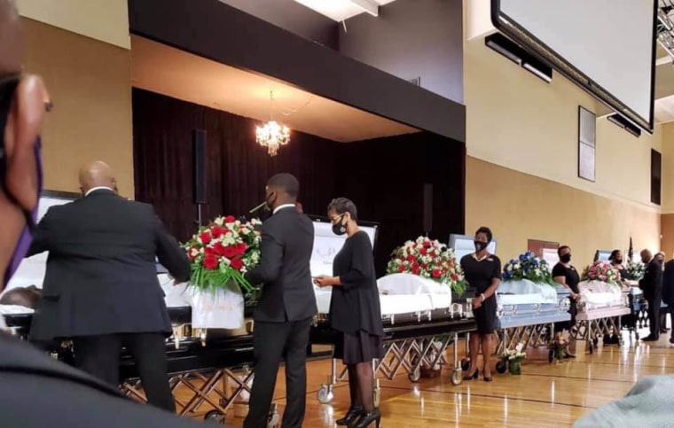 Five caskets lined up at the funeral for Sheletta Brundidge's relatives.