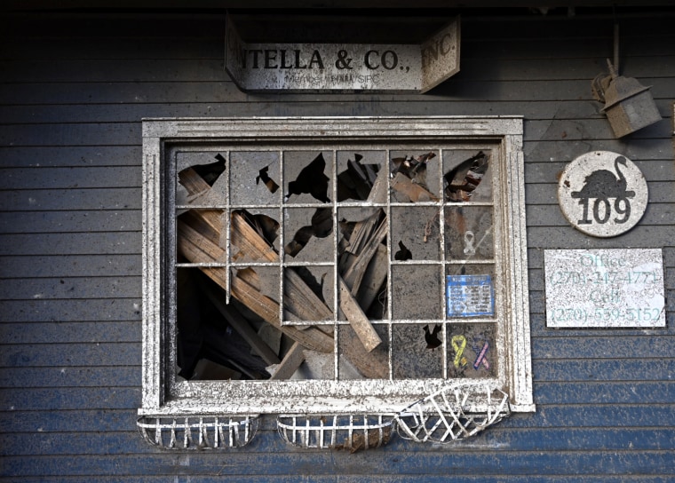 Image: Debris inside the smashed out windows of a local business in Mayfield.