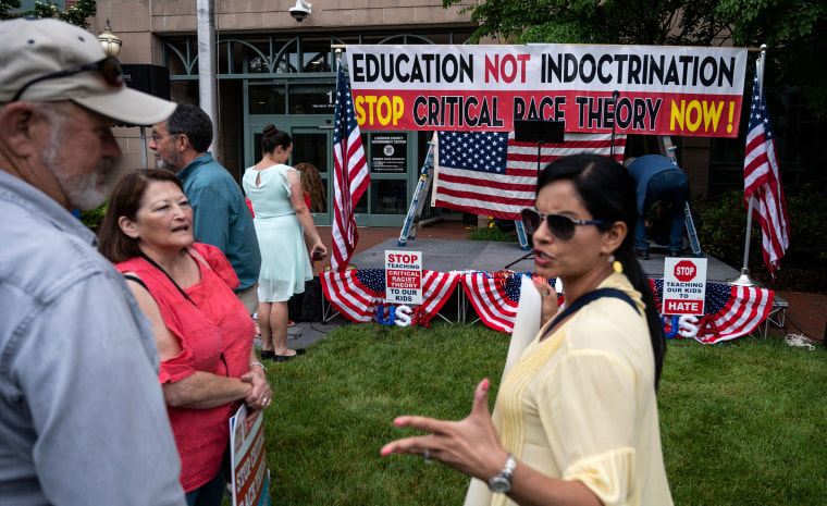 Image: Protesters talk before the start of a rally against critical race theory being taught in schools at the Loudoun County Government Center in Leesburg, Va., on June 12, 2021.
