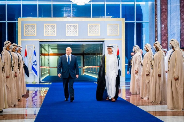 Image: Israeli Prime Minister Naftali Bennett walks with United Arab Emirates Foreign Minister Sheikh Abdullah bin Zayed Al Nahyan during a welcoming ceremony upon his arrival in Abu Dhabi