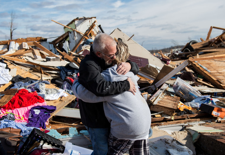 Image: Mike Castle hugs his daughter after the tornado in Dawson Springs