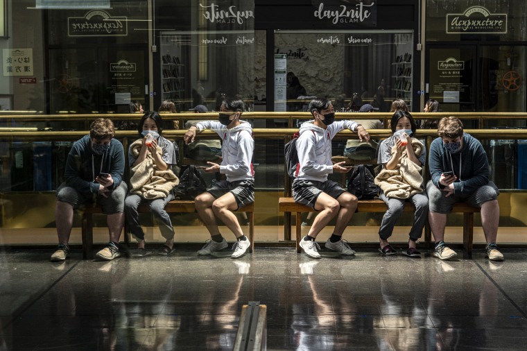 Shoppers rest on a bench inside the Japan Center in San Francisco on Aug. 25, 2021.