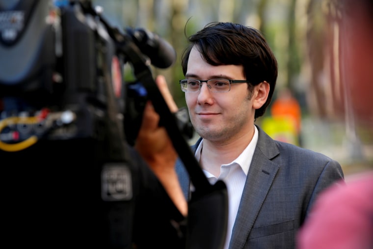 Former drug company executive Martin Shkreli is surrounded by news cameras as he exits U.S. District Court following the second day of jury deliberations in his securities fraud trial in the Brooklyn borough of New York City