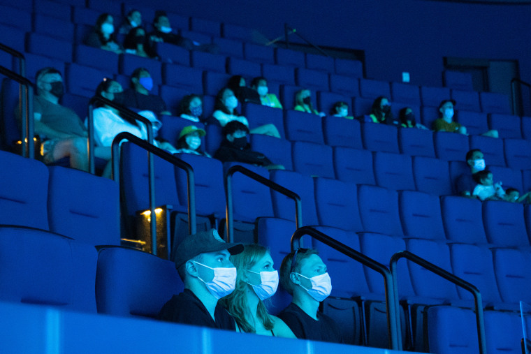 Image: People watch a movie inside a theater in Long Beach, Calif., on July 16, 2021.