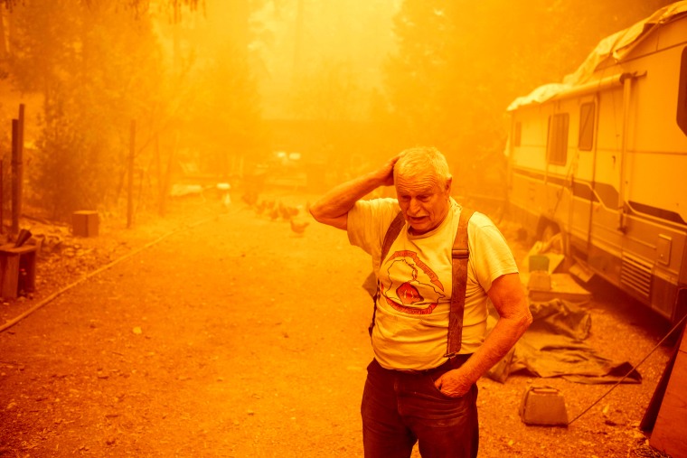 Image: Jon Cappleman prepares his home against the encroaching Dixie wildfire in Twain, Calif., on July 24, 2021.