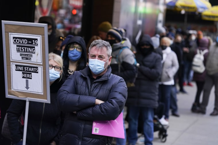 People wait in line at a Covid-19 testing site in Times Square, New York, on Dec. 13, 2021.