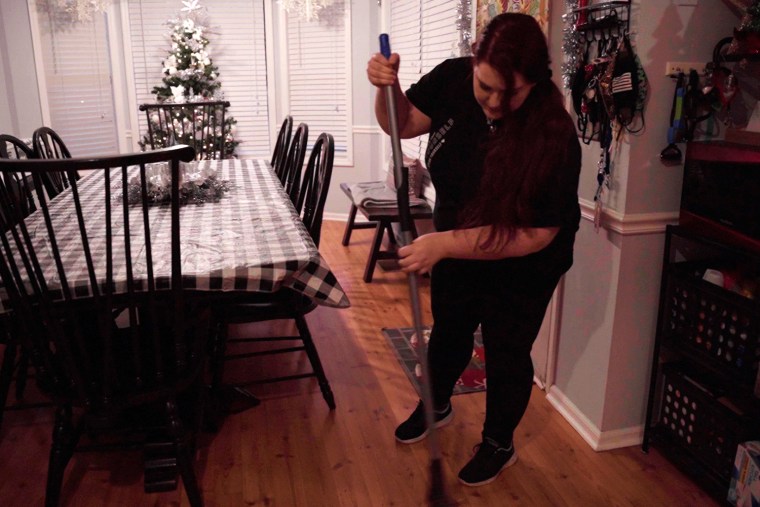 Image: Kathy Keel cleans her dining room floor