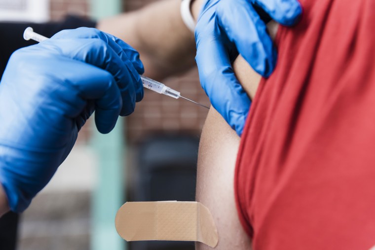 A health care worker administers a dose of the Pfizer-BioNTech Covid-19 vaccine at a pop up vaccination site at Hammons Field in Springfield, Mo., on Aug. 3, 2021.