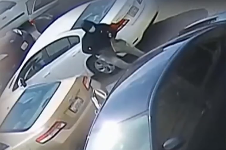 A suspect runs to a getaway car after robbing an elderly shopper in San Jose, Calif.
