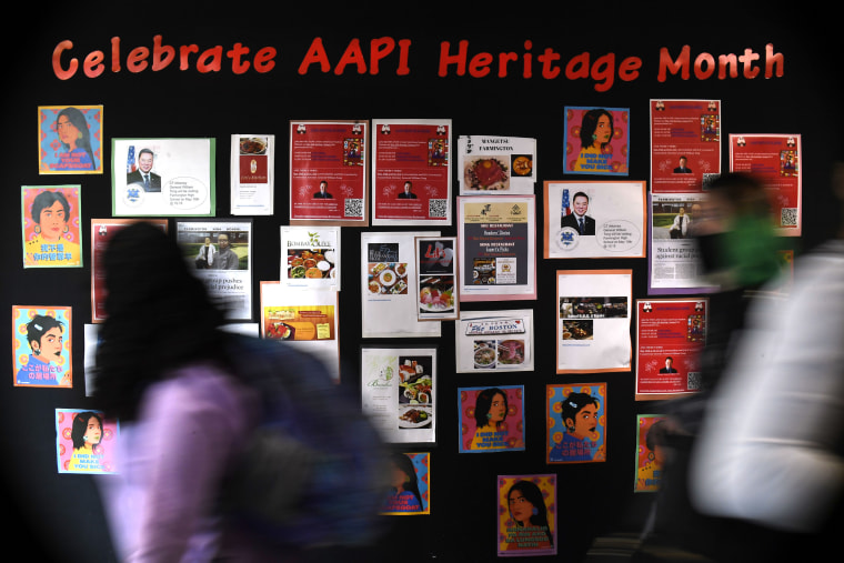 Students walk past a display for Asian Pacific American Heritage Month at Farmington High School in Farmington, Conn., on May 10, 2021.