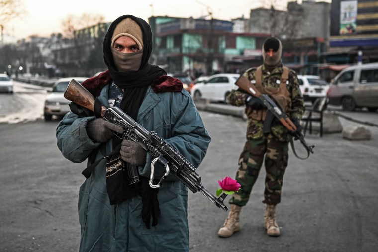 Taliban fighters stand guard at a checkpoint on a street in Kabul on December 17, 2021.