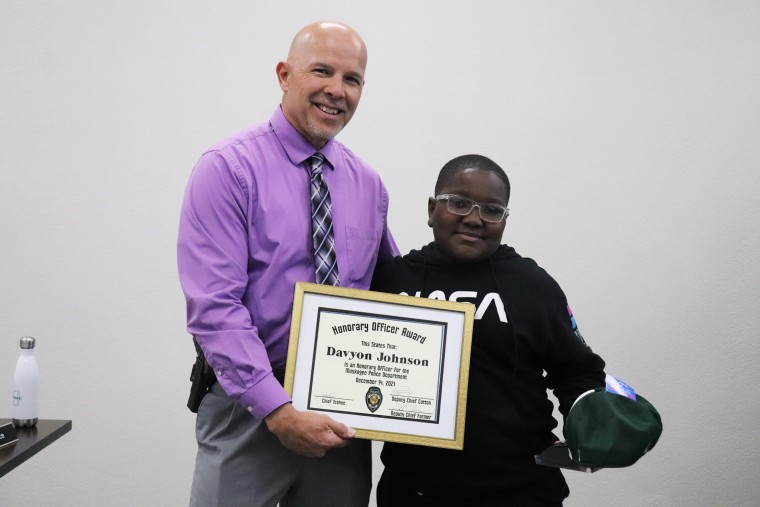 Davyon Johnson receives an honor from the Muskogee Police Department for using the Heimlich maneuver to save a classmate and later helping a woman with a walker get away from a housefire.