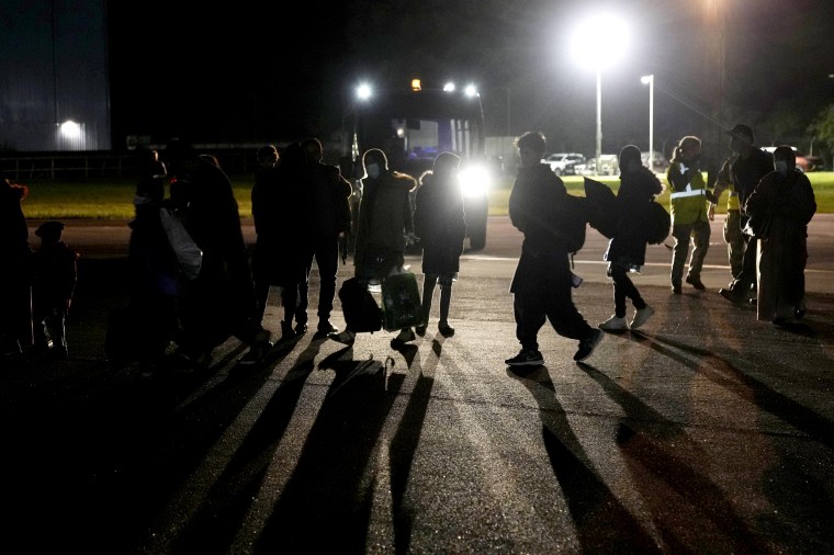 Afghans who fled their country after the Taliban seized power, arrive at RAF Brize Norton air base in England in August. 